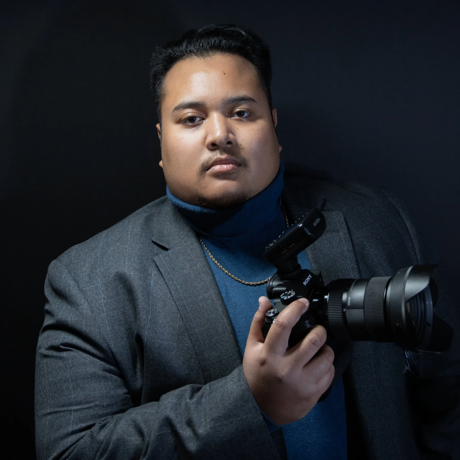 William, the photographer behind Creative Wills Photography, holding a Sony camera.